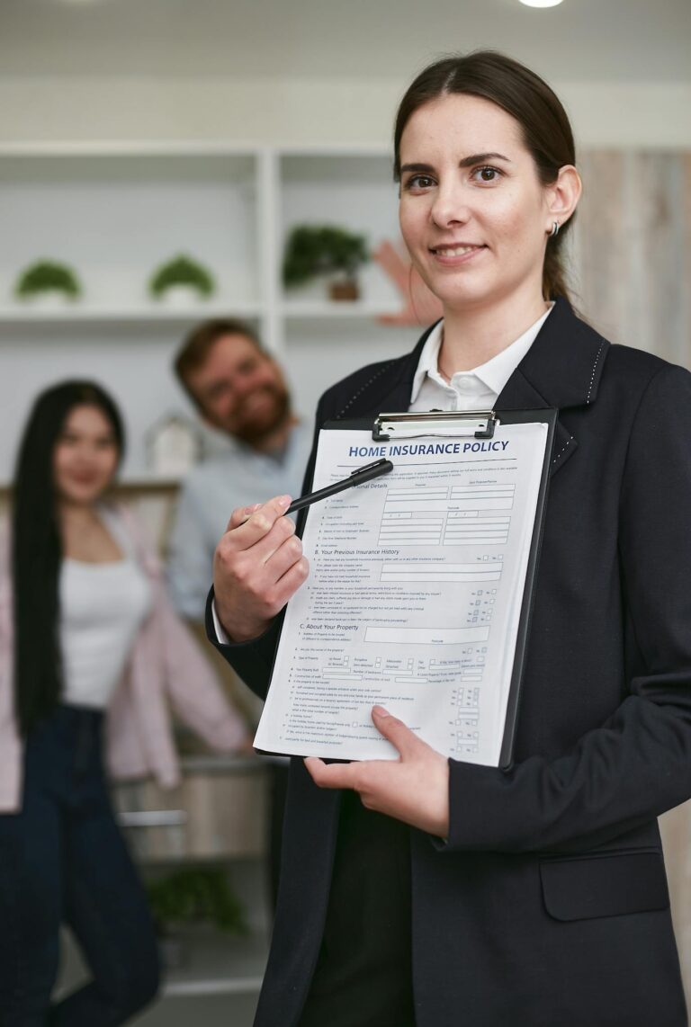 Confident businesswoman presenting a home insurance policy indoors to potential clients.